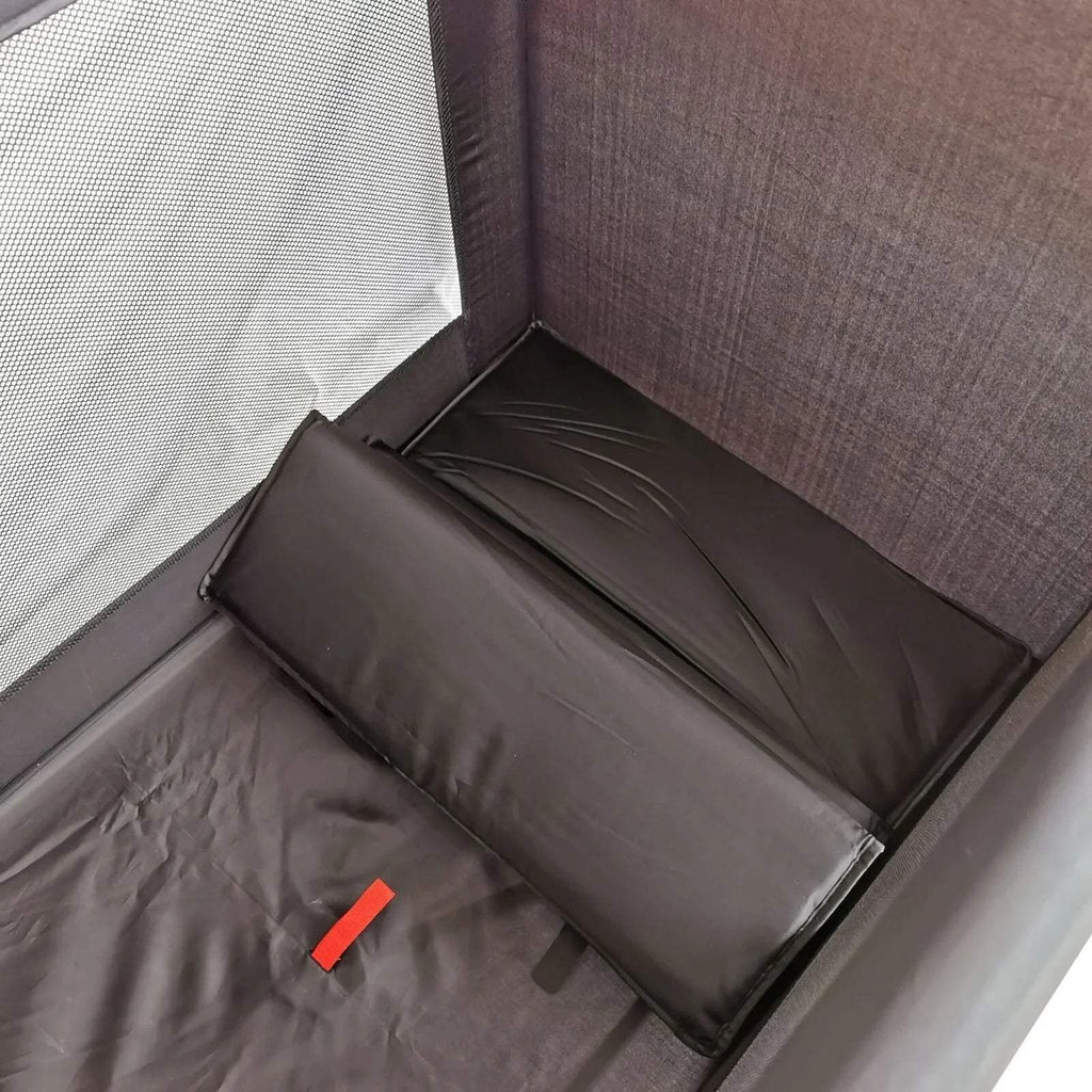 Black travel cot interior with gray padded mattress and zippered side walls