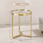 Gold round side table with geometric metal legs and clear glass top, gold tone