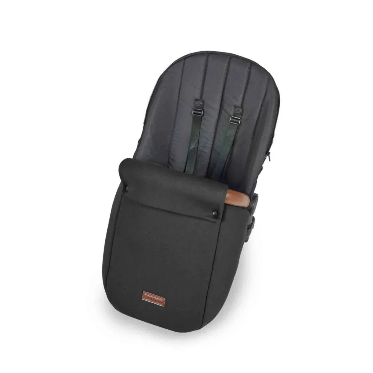 Dark stroller carrycot with black padded seat liner and buckle straps