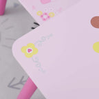 Close-up of white kids table corner with princess crown and hearts print, pink leg