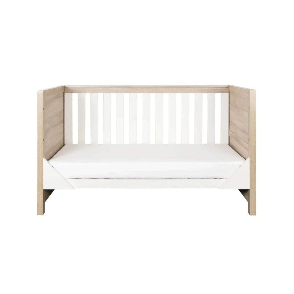 White and oak toddler daybed with vertical slats and side rails