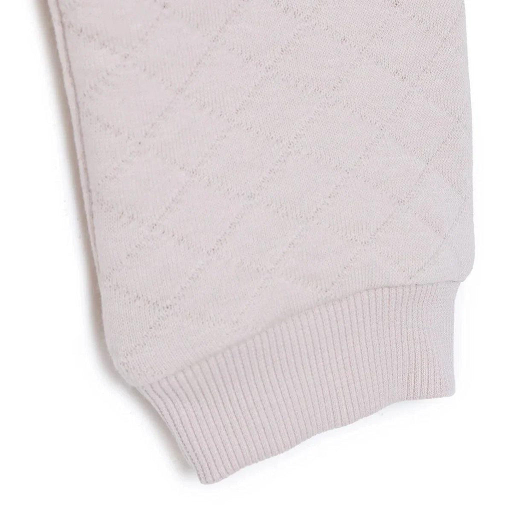 Beige quilted baby leggings with ribbed ankle cuffs