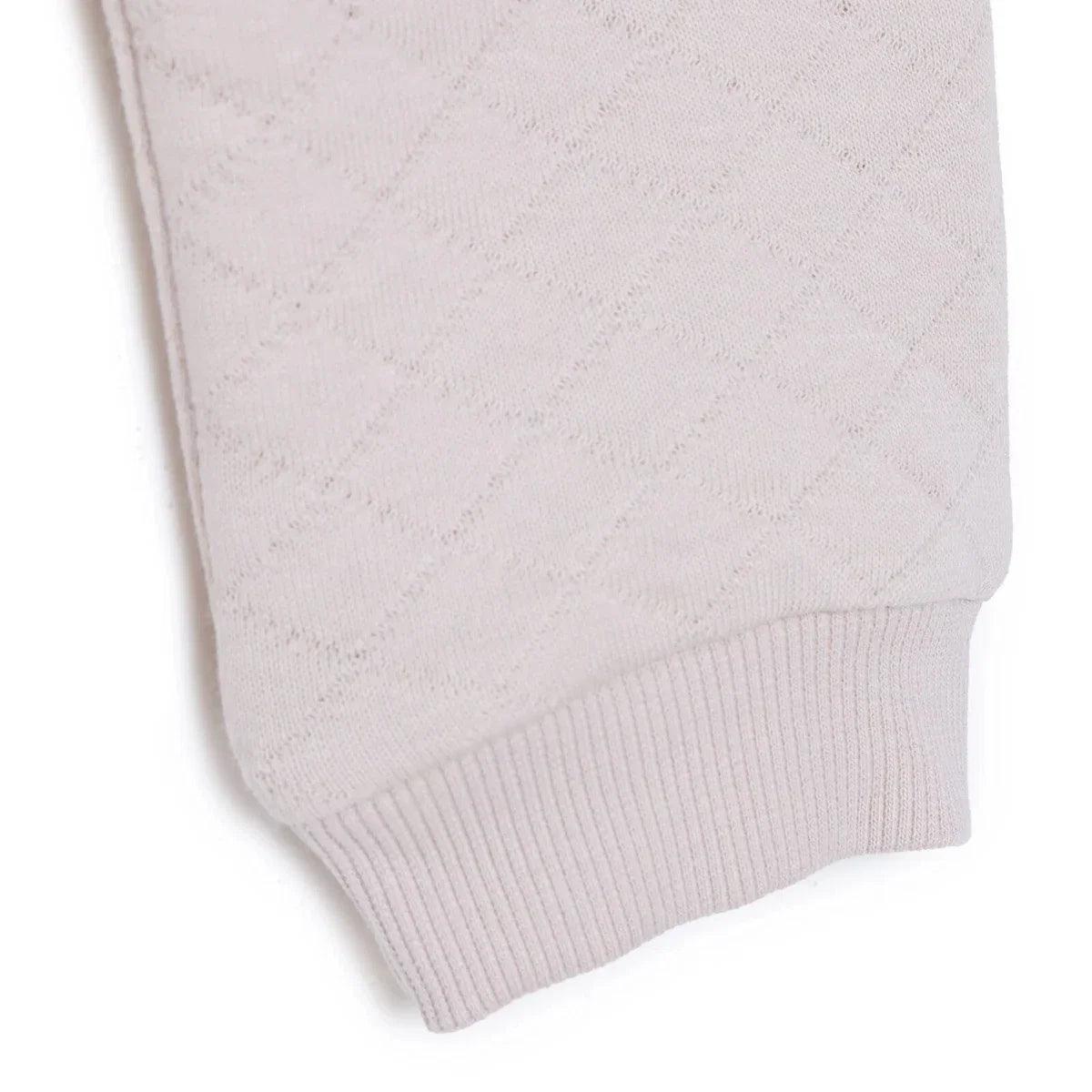 Beige quilted baby leggings with ribbed ankle cuffs