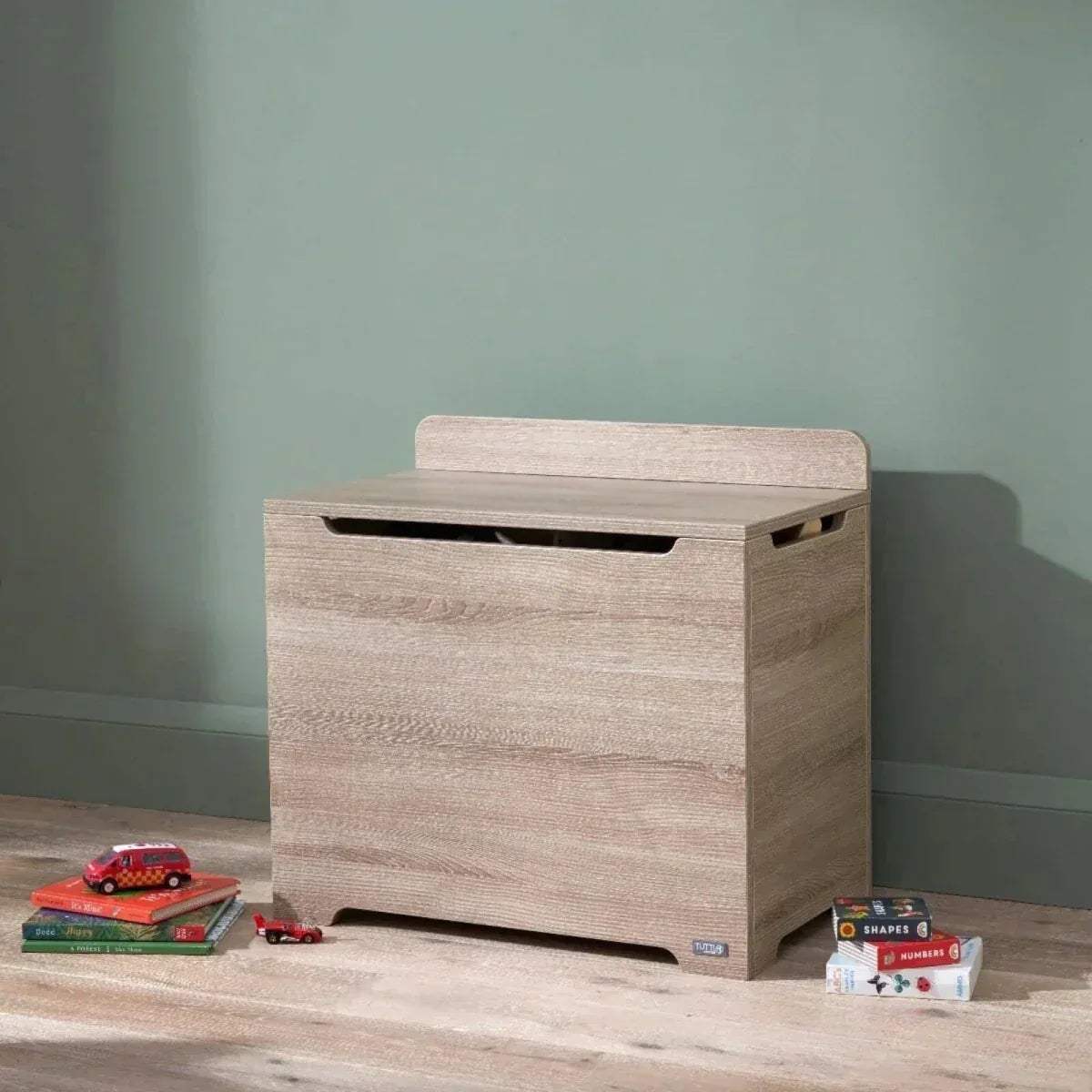 Oak wooden toy box with flip-top lid and front handhold slot