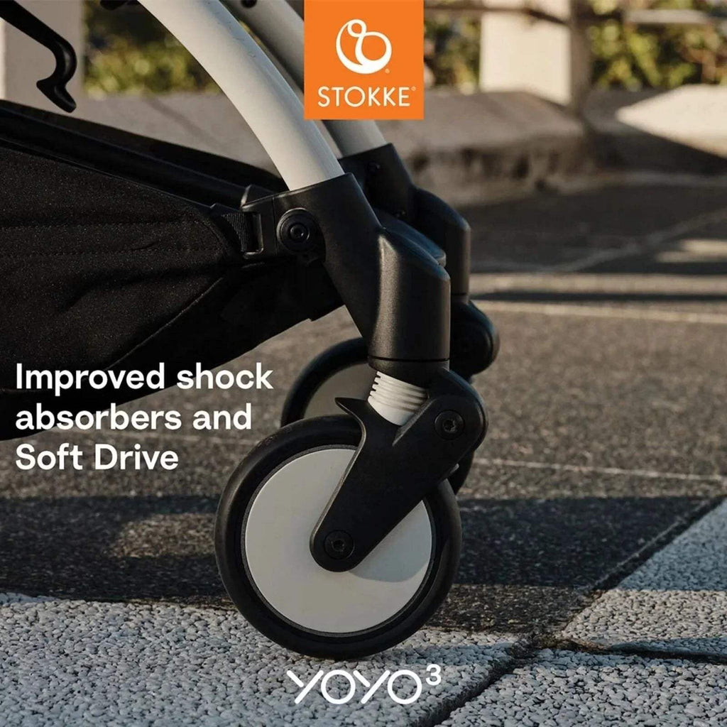 Stokke stroller wheel and suspension joint on white frame