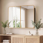Wall-mounted bathroom mirror cabinet with two framed mirrored doors and rounded corners