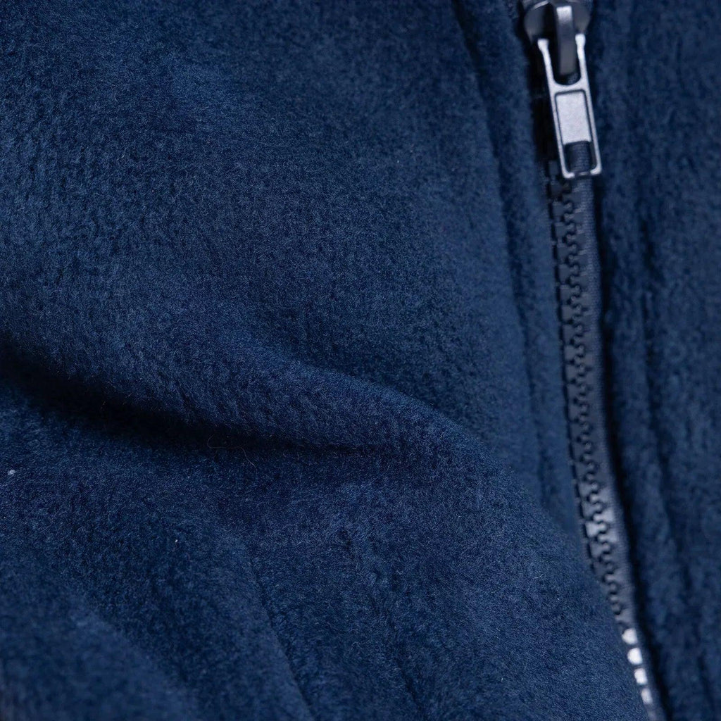 Navy blue fleece gilet close-up of seam and zipper