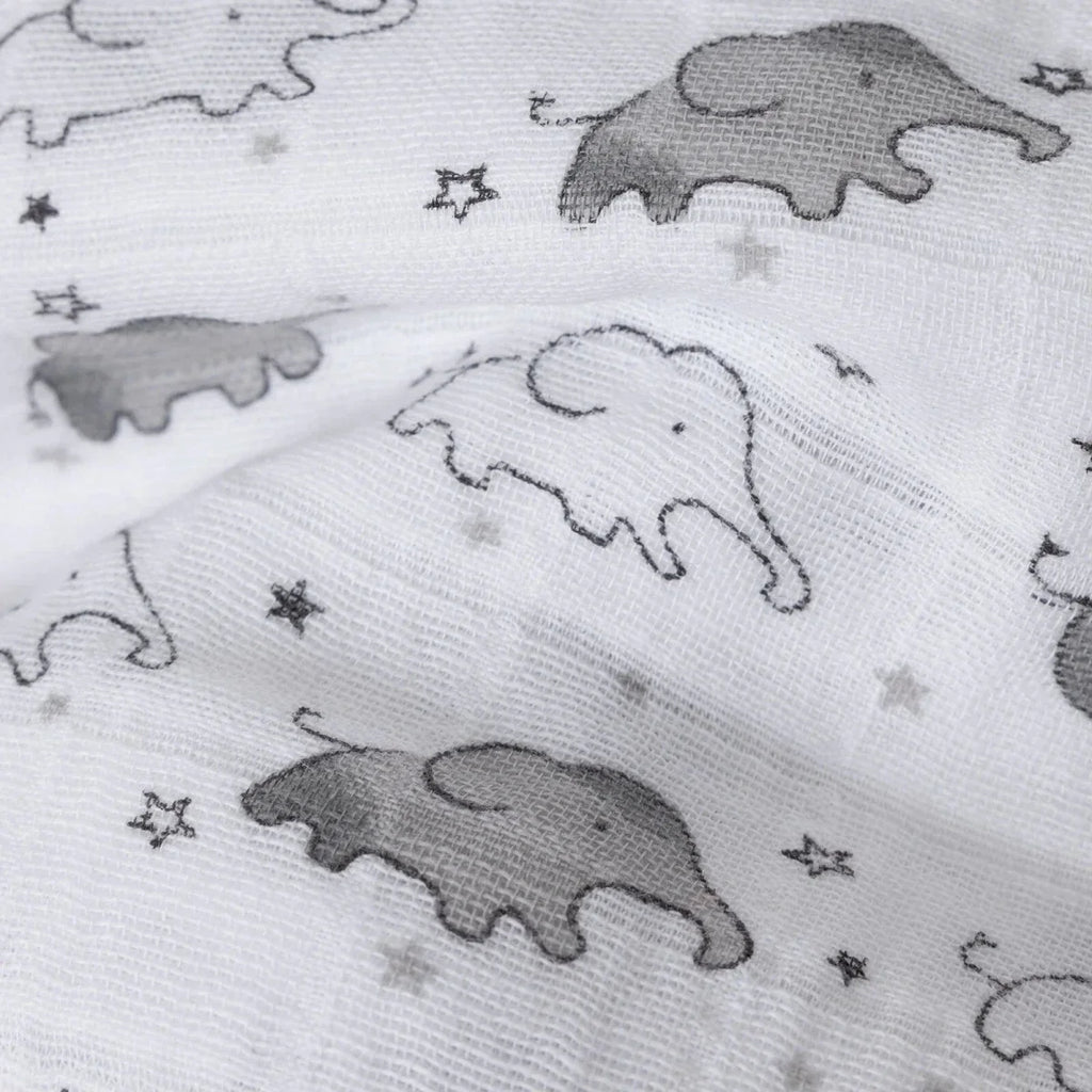 White muslin blanket close-up with gray elephants and tiny star details