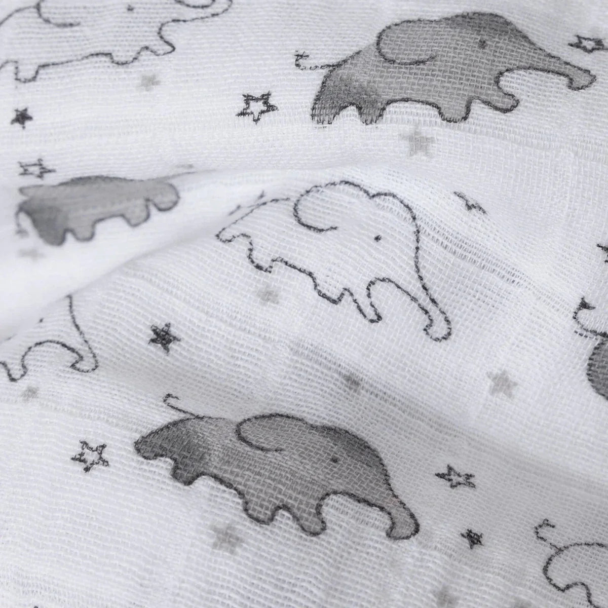 White muslin blanket close-up with gray elephants and tiny star details