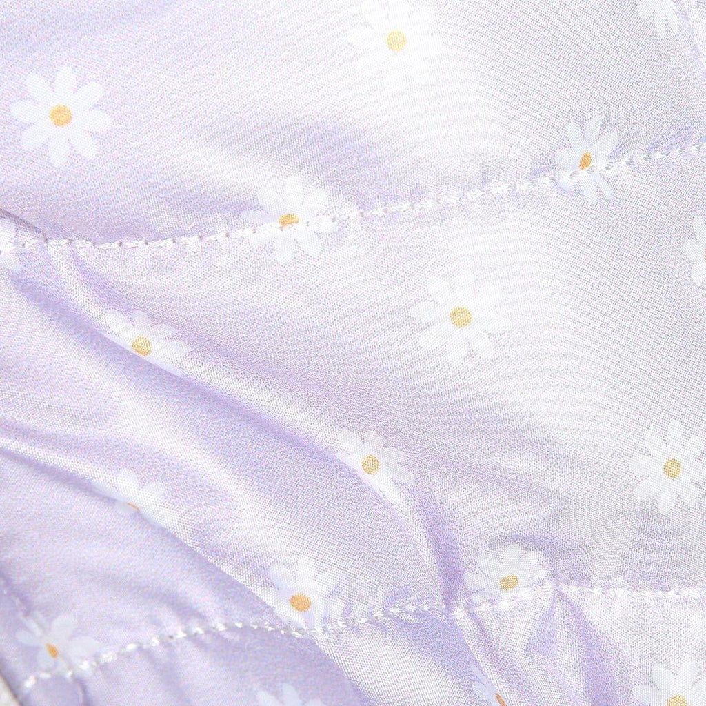 Lilac quilted fabric with small yellow daisy pattern