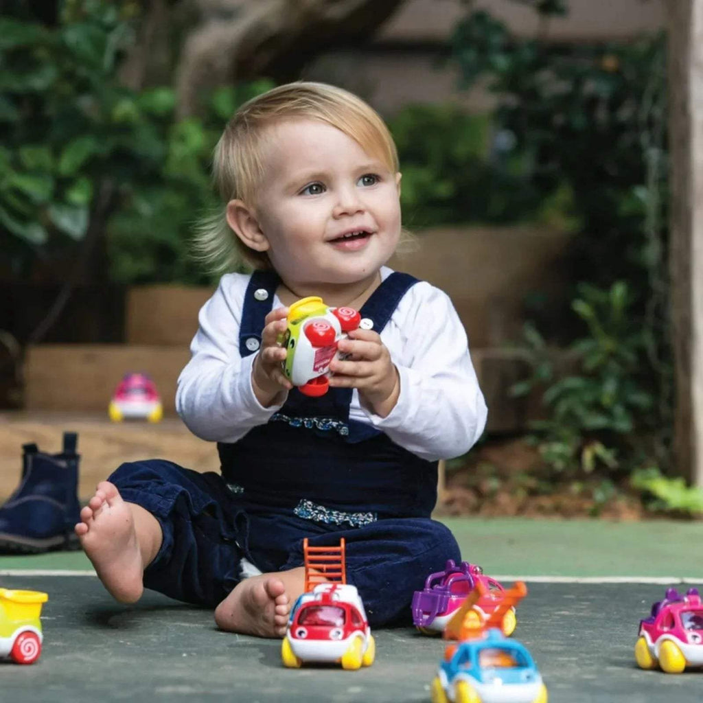 Red and white mini toy car with blue wheels, with small purple toy car nearby