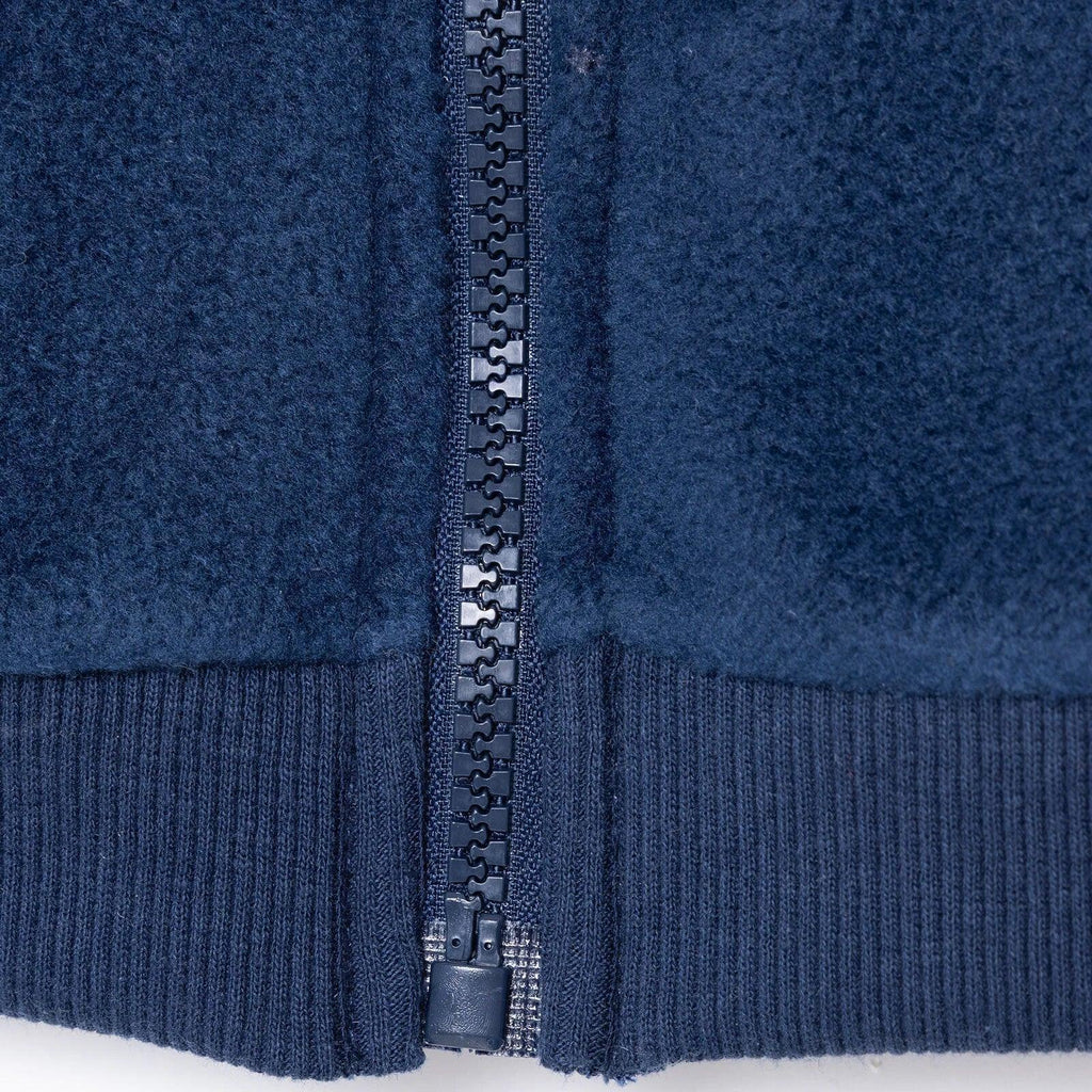 Navy blue fleece gilet with ribbed hem and front zipper close-up
