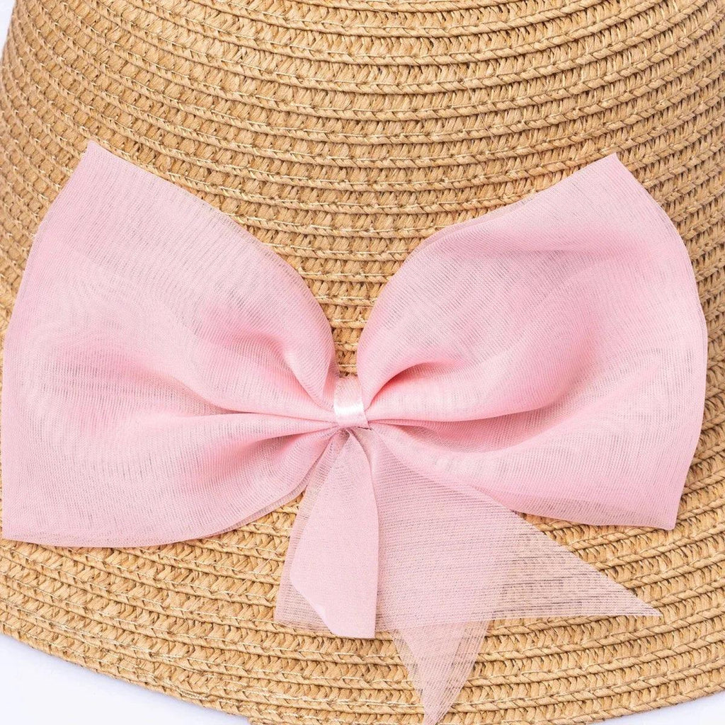 Straw bucket hat close-up: pink bow ribbon with layered tails on brim