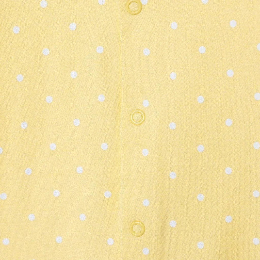 Yellow polka-dot baby sleepsuit with button snaps down the center