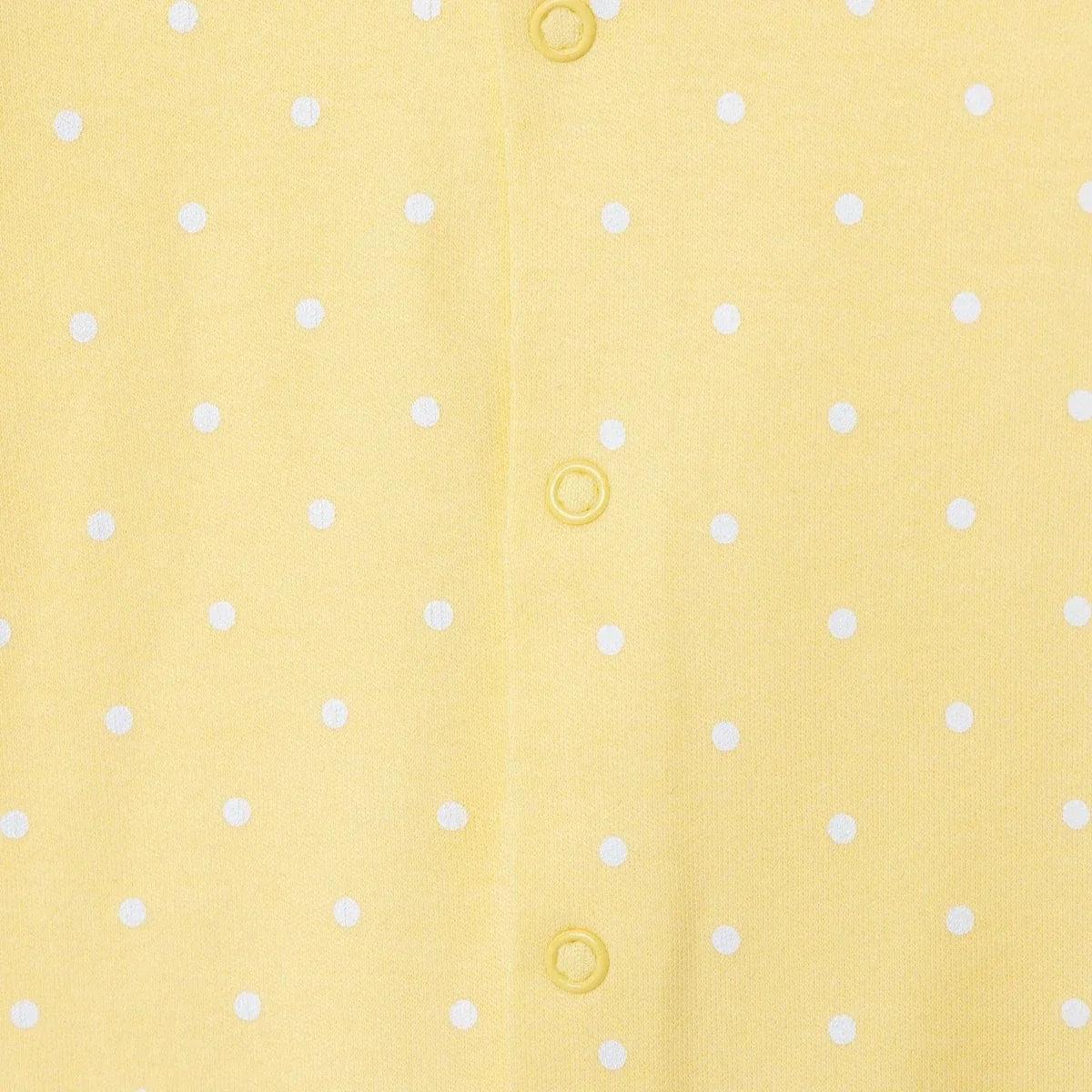 Yellow polka-dot baby sleepsuit with button snaps down the center