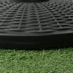 Close-up of black rattan-pattern parasol base rim against grass
