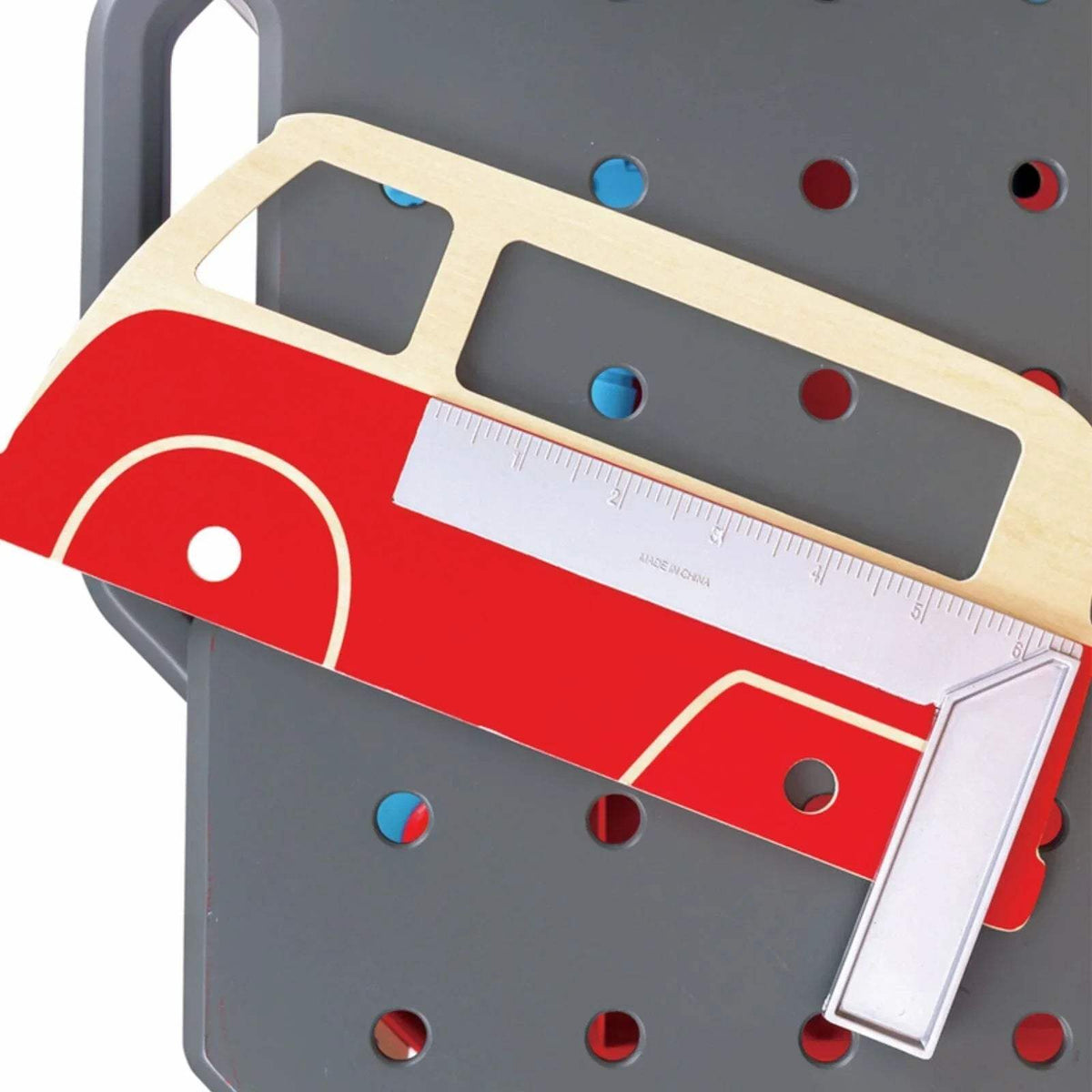 Toy red car repair front with white ruler and blue peg details on workbench