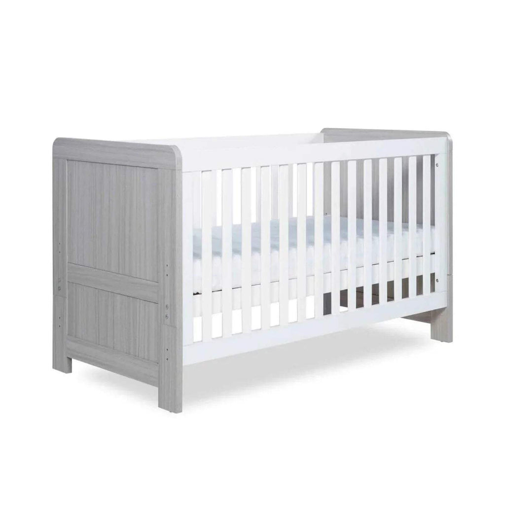 Ash grey cot bed with white slatted side rails and paneled footboard