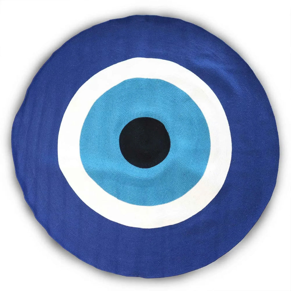 Navy round cotton rope eye rug with sky-blue center, white rings, and black pupil.