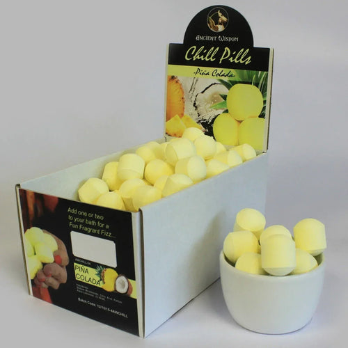 Chill Pills mini bath bomb box with yellow bath bombs in a white bowl