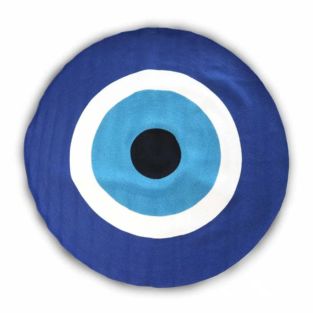 Round eye rug in navy cotton rope with teal center, white rings, and black pupil