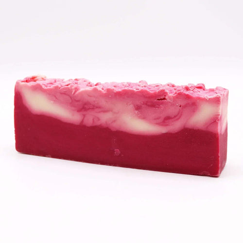 Red-pink shea butter soap loaf with pale inner swirl
