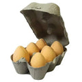 Bath eggs in open tray, yellow and pale orange, with one egg lifted