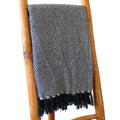 Navy zigzag throw blanket with black tassel fringe edge