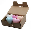 Set of 6 heart-shaped bath bombs in pastel blue, purple, pink, and beige