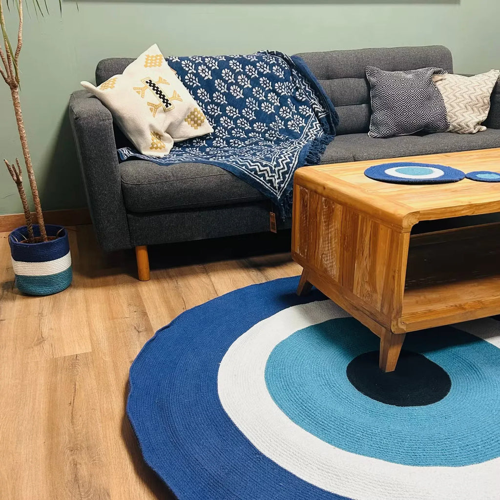 Round cotton rope eye rug in navy and sky blue with white ring and black center.