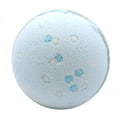 Blue snowflake bath bomb with white and light-blue snowflake confetti