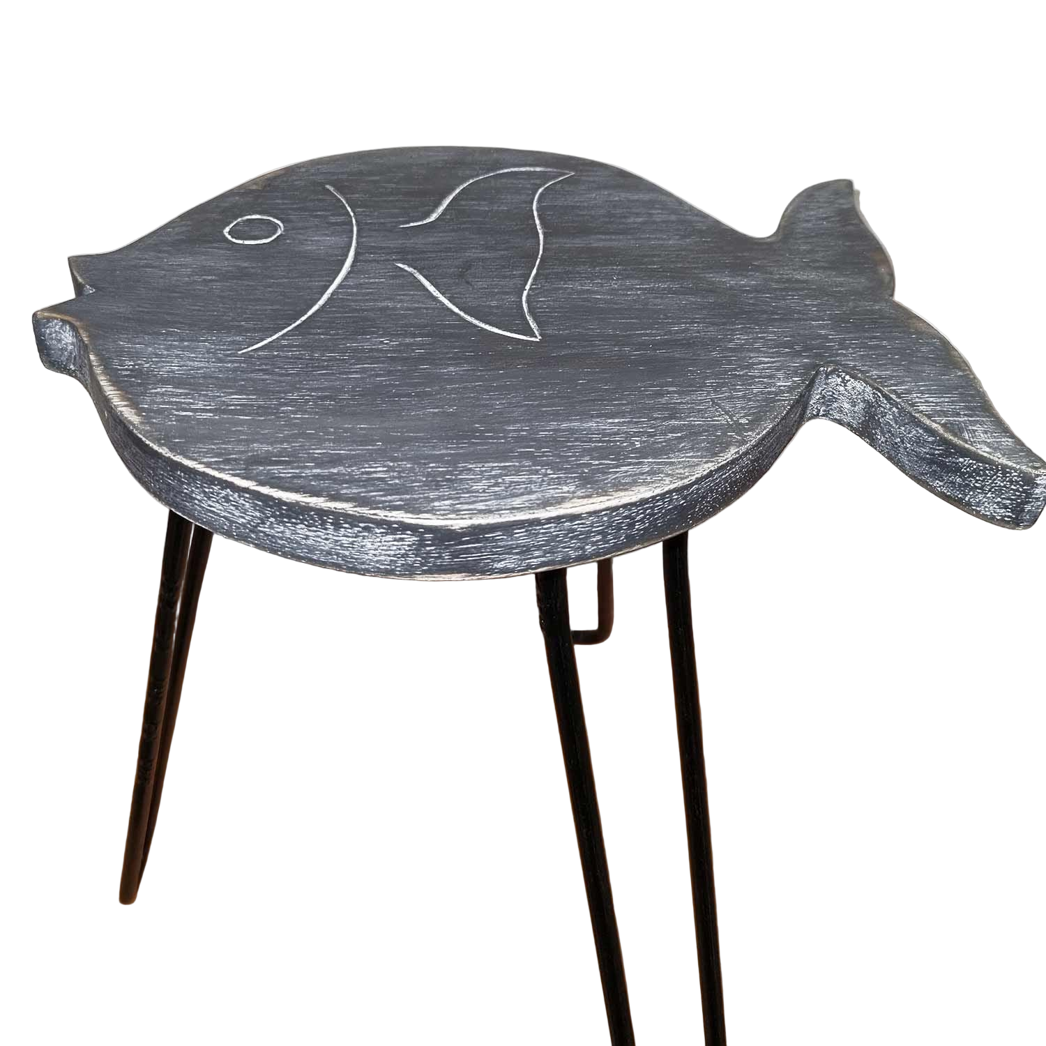 Fish-shaped wooden stool with black legs on a wooden floor.