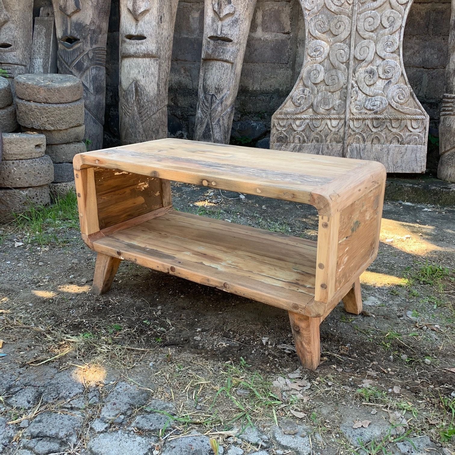 Wooden bench with carvings in the background