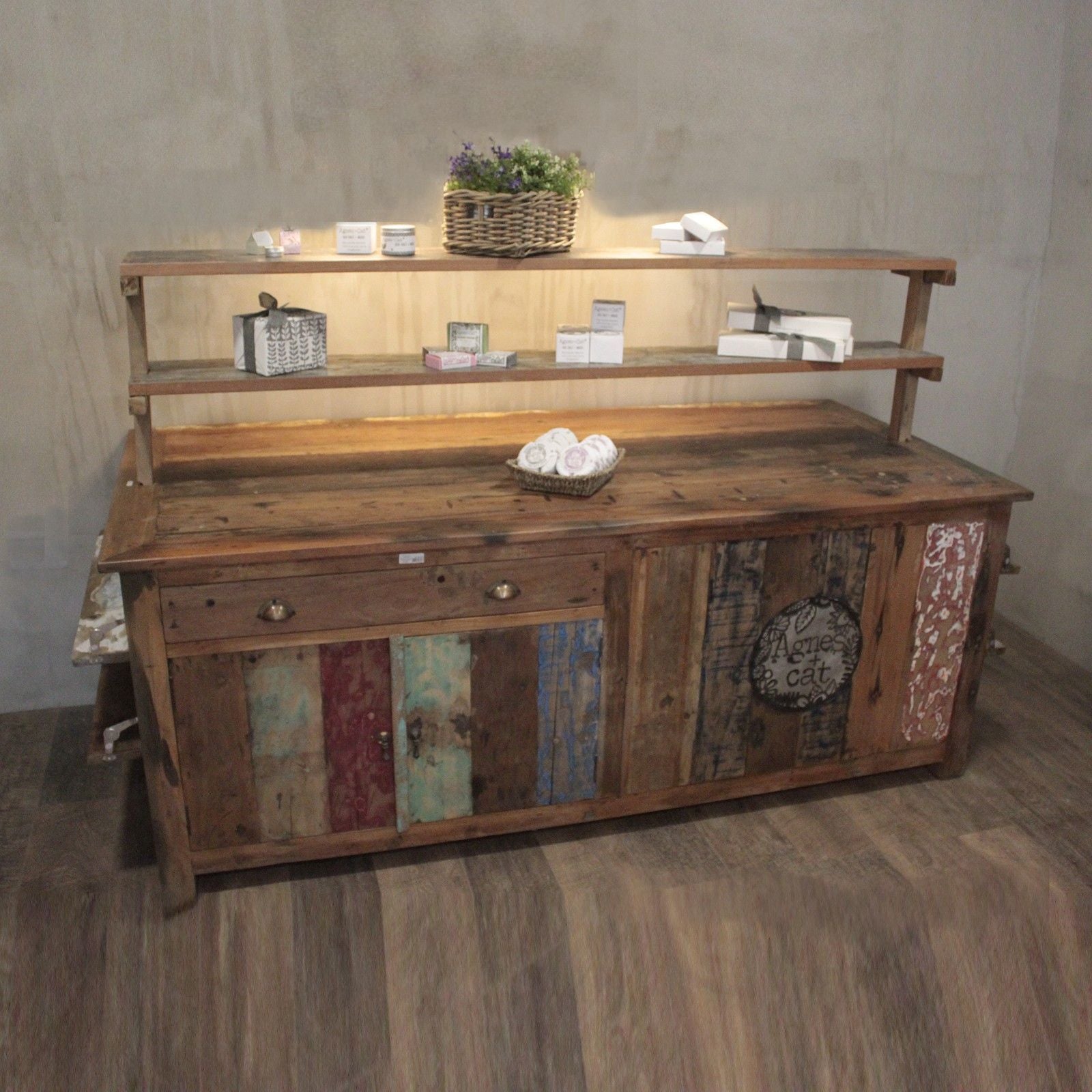 Wooden shelf with decorative items against a plain wall