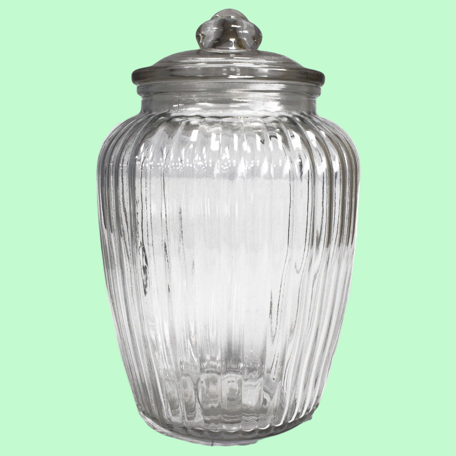 Clear glass jar with ribbed design and silver lid on a white background