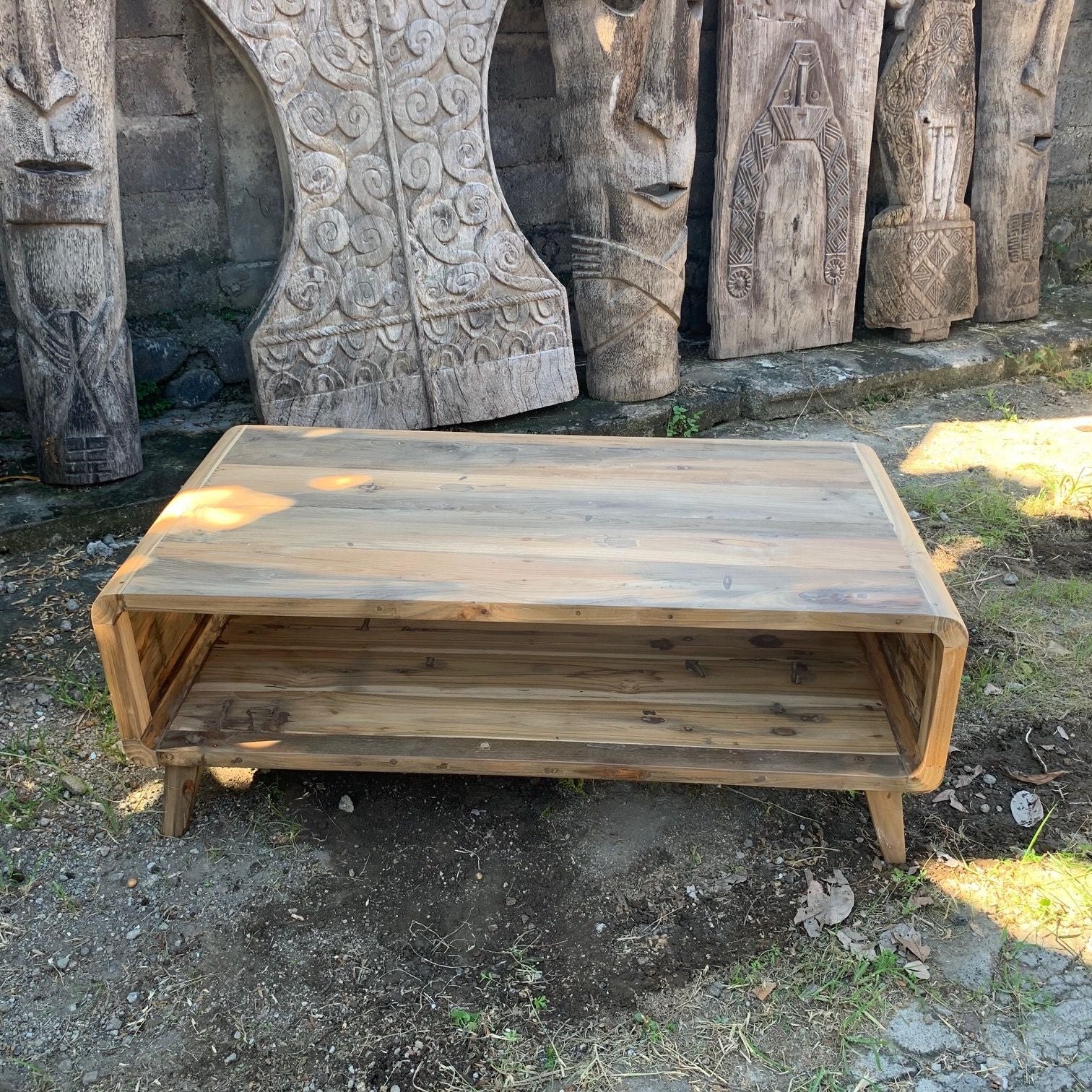 Wooden bench in front of stone carvings