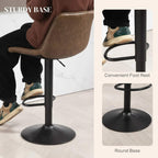 Brown bar stool with round steel base and curved footrest; diamond-quilted PU upholstery