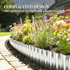 Corrugated galvanized steel edging strip along a garden bed border, silver ridged design