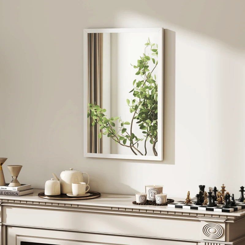 White framed rectangular mirror reflecting greenery on tabletop