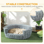 Grey wicker oval pet bed with beige cushion, outdoor patio styling