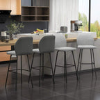 Light grey bar stools with curved backs, black legs, and built-in footrests