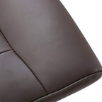 Close-up of brown padded recliner arm and seat upholstery with smooth PU leather finish.