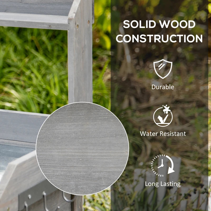 Grey wooden potting table frame with side hooks and textured grain detail