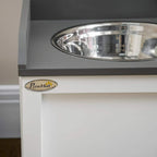 White raised pet bowl cabinet with stainless steel bowl and PawHut logo plate
