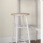 Round light oak-tone stool top with white legs and lower support bar.