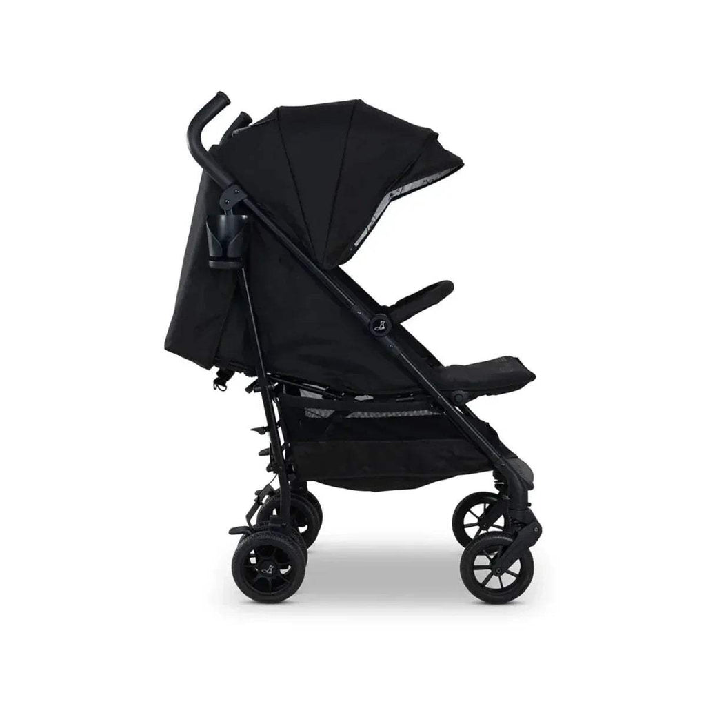Lightweight stroller reclined with black canopy and seat harness, side view