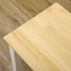 Close-up of light pine tabletop on a white wood bench frame.