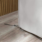 Grey patio furniture cover corner with black securing strap at the hem