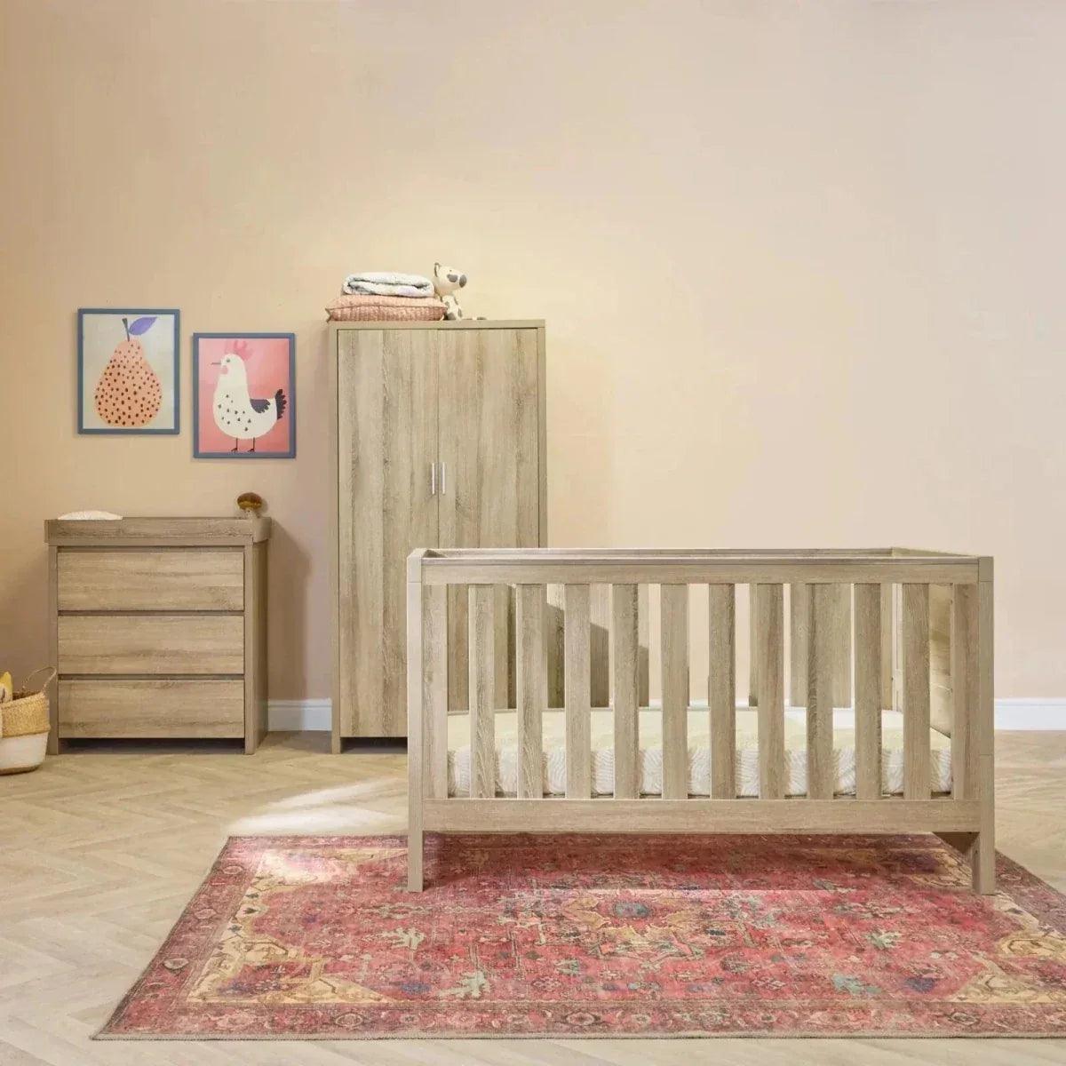 Oak cot bed and matching dresser in light wood finish, child room set
