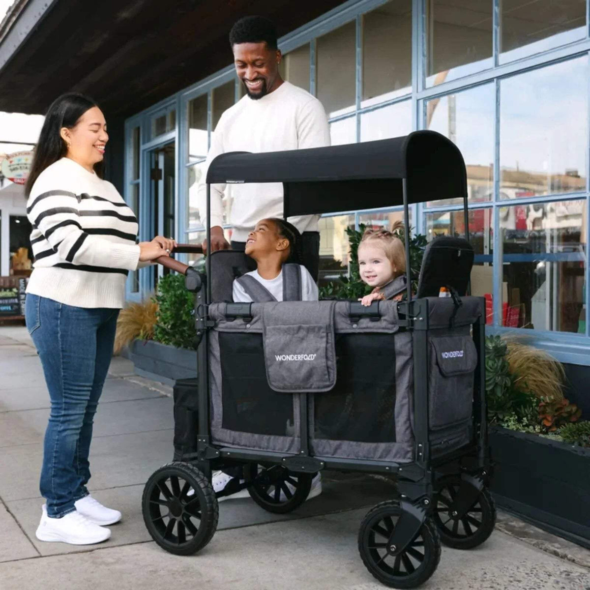 Black stroller wagon with open front canopy and side panels